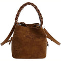 Brown suede mini bucket bag with braided top handle and adjustable crossbody strap