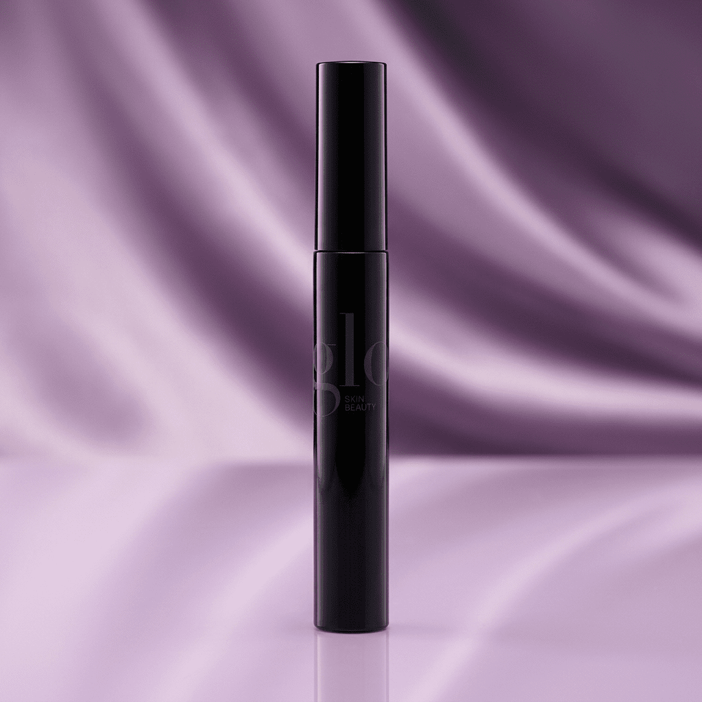 Glo black mascara tube against a lavender satin studio background